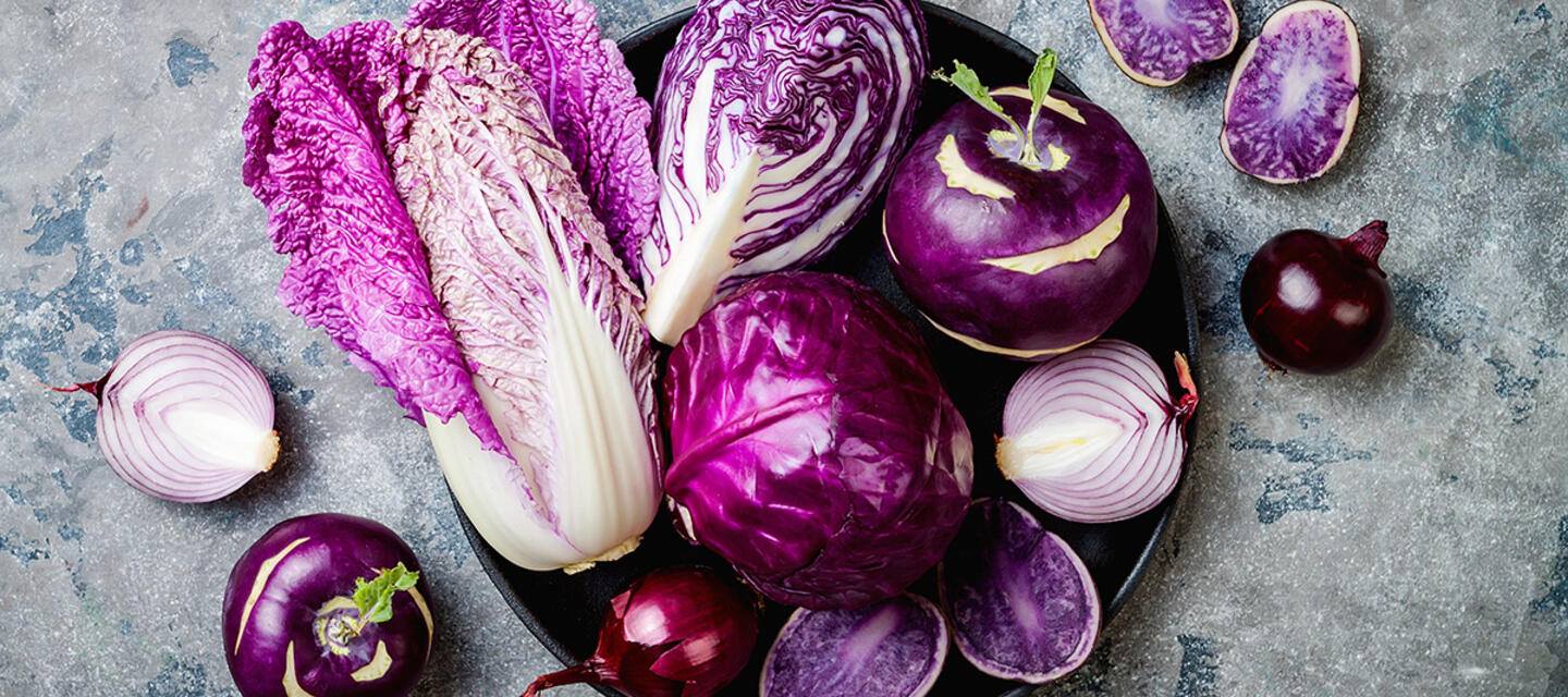 A bowl of purple vegetables on grey table